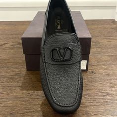 Valentino Garavani Driving Shoes In Grained Calf Leather Flat Driving Heel Round Toe Black Tone Signature V-Logo Ornament Leather Lining Branded Valentino Rubber Driving Sole Slip-On Style Made In Italy Brand New In Box Box Has Some Marks On Them , See Photos For Details Size 45 All Sales Are Final Luxury Round Toe Moccasins For Business, Luxury Black Moccasins For Work, Luxury Slip-on Leather Shoes For Business, Luxury Leather Sole Moccasins For Business, Business Leather Loafers With Textured Detail, Luxury Leather Shoes With Textured Sole For Business Casual, Luxury Business Moccasins With Leather Sole, Elegant Textured Leather Loafers, Black Business Moccasins With Branded Insole