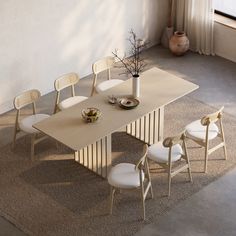 a dining table with four chairs around it