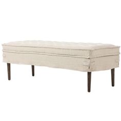 a white bench sitting on top of a wooden leg rest with an upholstered seat