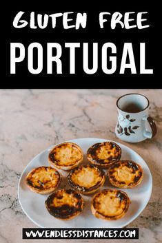 a white plate topped with mini pies next to a cup of coffee on a marble table