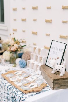 the table is set up for a baby's first birthday party with blue and white decorations