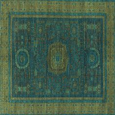 a green rug with an intricate design on the top and bottom, in different colors