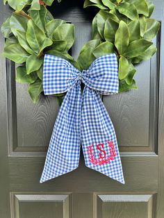 a blue and white gingham wreath with the word monogrammed on it