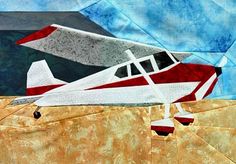 a red and white plane sitting on top of a piece of paper next to a blue sky