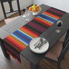 a table with place settings and fruit on it