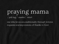 a black t - shirt with the words praying mama written in white ink on it