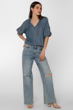 The Kenna Blouse offers an elegant style with its smocked neck, pleated elbow puff sleeve, and V-neck. It's perfect for dressier occasions, while still remaining comfortable and easy to wear. Material: 100% Tencel™ Eco-Friendly Color: 405 Malibu Machine wash cold or hand wash Model is 5'9" and wearing a size S Imported Casual Billowy V-neck Tops, Casual Top With Gathered Balloon Sleeves, Casual V-neck Cotton Puff Sleeve Top, Casual Tops With Gathered Balloon Sleeves, Spring Casual Puff Sleeve Blouse, Spring Casual Solid Puff Sleeve Top, Spring Peasant Top With Blouson Sleeves And Relaxed Fit, Casual Billowy Tops With Puff Sleeves, Casual V-neck Puff Sleeve Top For Daywear