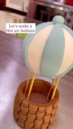 a hot air balloon sitting on top of a wooden basket