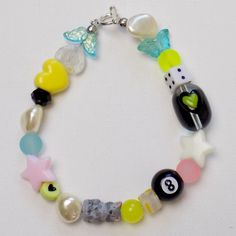 a bracelet with beads and charms on it