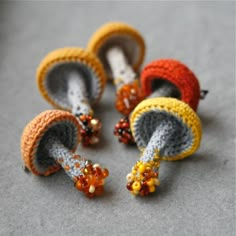 small crocheted objects sitting on top of a gray floor next to each other