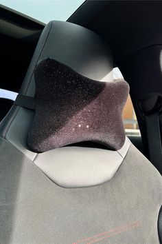 the interior of a car with black and silver cloth on it's seat cushion