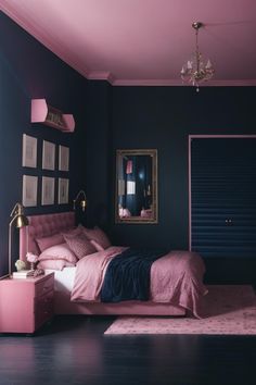 a pink and blue bedroom with a bed