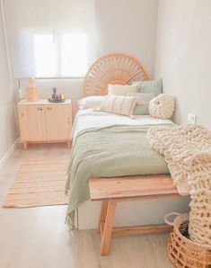 a bedroom with white walls and wooden furniture