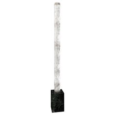 a black and white marble column on a stand