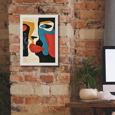 a computer monitor sitting on top of a wooden desk next to a brick wall in an office