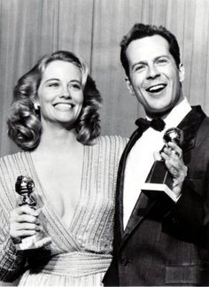 the man and woman are posing with their oscars