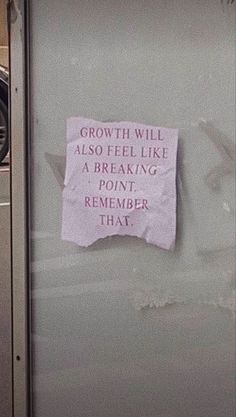 a sign posted on the side of a door that says growth will also feel like a breaking point