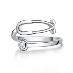 PRICES MAY VARY. Design:This stethoscope ring is not only a fine piece of jewelry, but also a unique design that pays tribute to medical professionals and is suitable for medical professionals. It is also inlaid with twelve birthstones, each representing a different month, which not only highlights personality but also has commemorative significance. The adjustable opening design makes it suitable for various finger sizes, comfortable and convenient to wear. Whether it is worn daily or on specia Stethoscope Ring, Medical Assistant Week, Heartbeat Jewelry, Heartbeat Ring, Heart Beat Ring, Doctor Dentist, Surgeon Doctor, Opening Design, Medical Assistant