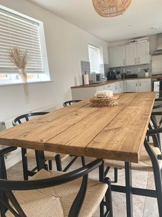 a wooden table sitting in the middle of a kitchen