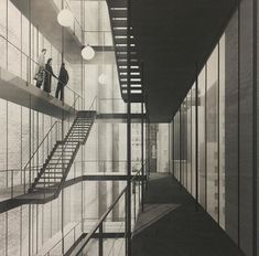 two people are walking up the stairs in an office building with glass walls and metal railings