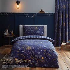 a bed room with a neatly made bed next to a night sky scene wallpaper