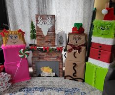 some very cute looking christmas decorations in front of a fire place with presents on it