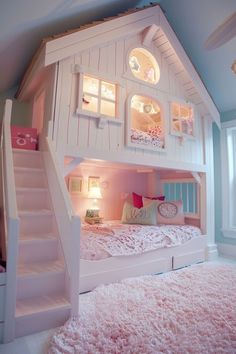 a child's bedroom with a doll house bed and stairs to the second floor