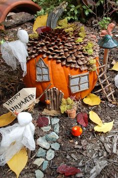 there is a small pumpkin house on the ground