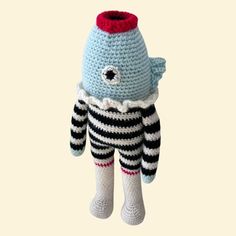 a crocheted stuffed animal with black and white stripes on it's body