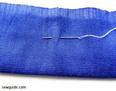 a piece of blue fabric with thread on it