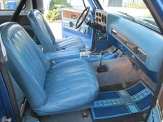 the interior of a car with blue leather seats and matching dash mats on the floor