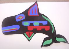 a piece of art that looks like a whale with different colors and shapes on it