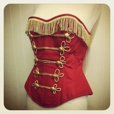 a red corset with gold trimmings on it