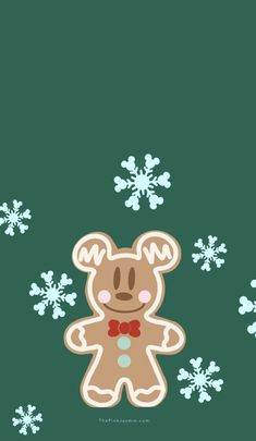 a teddy bear with snowflakes in the background