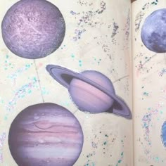 an open book with pictures of planets on it and stars in the sky around them