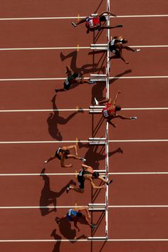 three athletes are competing in a race on the track