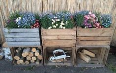 three wooden planters filled with different types of flowers