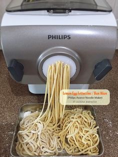 noodles being cooked in an electric pasta maker