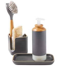 a toothbrush, soap dispenser and brush holder on a white background