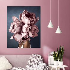 a living room with pink walls and flowers in the vase on the wall above the couch