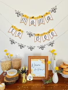 a table topped with lots of food next to a sign that says welcome to bees