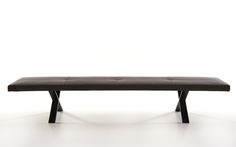 a black bench sitting on top of a white floor