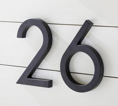 the number twenty two is shown on a white wall with black metal letters and numbers