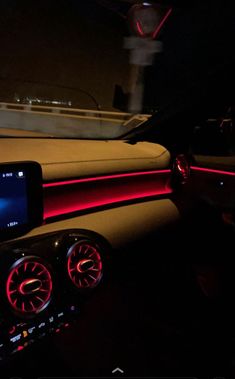 the interior of a car is lit up with red and blue lights, while it's dash light displays