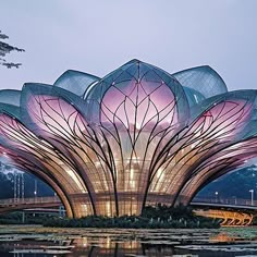 a large flower sculpture sitting on top of a body of water