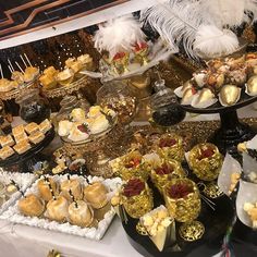 a table topped with lots of desserts and pastries