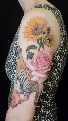 a woman with a sunflower and tiger tattoo on her arm