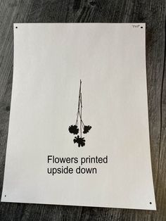 a piece of paper that has flowers printed upside down on it with the words flowers printed upside down