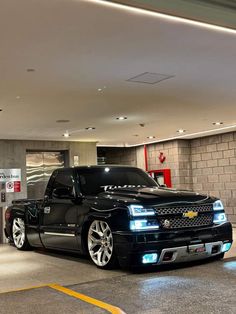 a black pickup truck parked in a garage