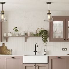 a kitchen filled with lots of counter top space next to a white sink and wooden cabinets